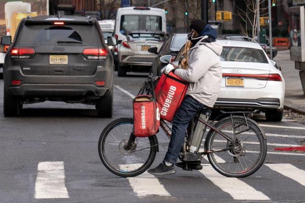 A Grubhub food deliveryman is seen here on Water St. near Whitehall St. in Manhattan on Thursday, Dec. 24, 2020. 