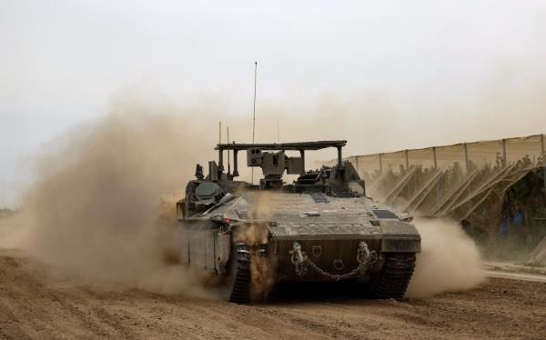 An Israeli tank rolls along the border with the Gaza Strip on February 23, 2024, amid o<em></em>ngoing battles between Israel and Hamas.