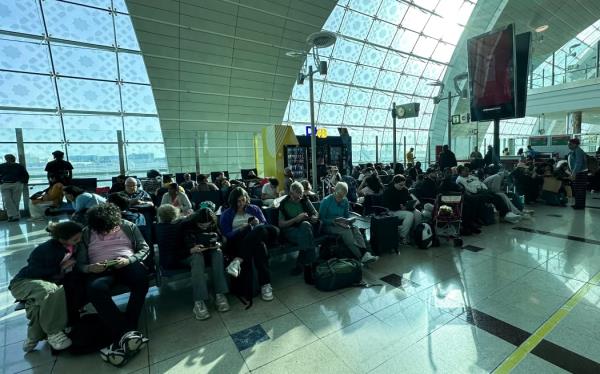 Passengers wait for their flights at the Dubai Internatio<em></em>nal Airport in Dubai on April 17, 2024. Dubai's major internatio<em></em>nal airport diverted scores of incoming flights on April 16 as heavy rains lashed the United Arab Emirates, causing widespread flooding around the desert country. Dubai, the Middle East's financial centre, has been paralysed by the torrential rain that caused floods across the UAE and Bahrain and left 18 dead in Oman on April 14 and 15. (Photo by AFP)