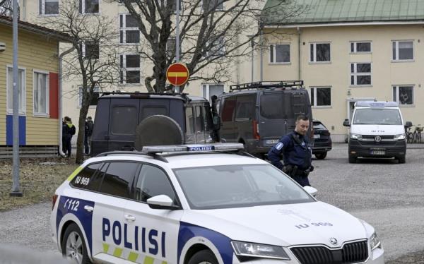 Finnish police officers and police vehicles are seen at the primary Viertola comprehensive school wher<em></em>e a child opened fire and injured three other children.