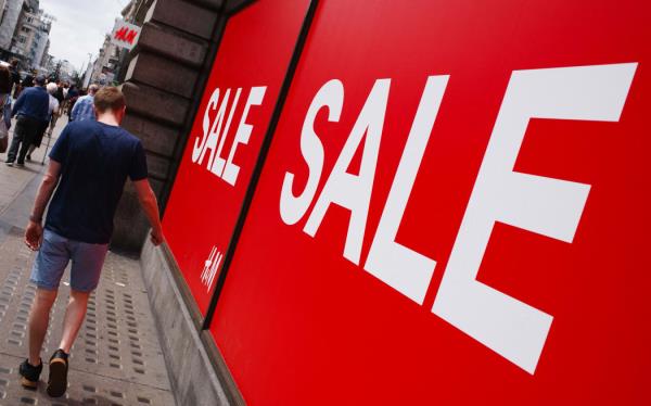 Shoppers walk past sales signs outside a branch of fast fashion retailer H&M on Oxford Street in London, England, on July 13, 2019. New retail sales figures for the UK, covering June 2019, are to be released by the Office for Natio<em></em>nal Statistics on Thursday, July 18. (Photo by David Cliff/NurPhoto) (Photo by David Cliff / NurPhoto / NurPhoto via AFP)