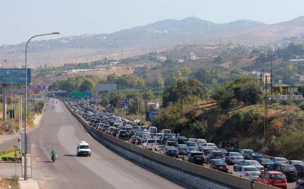 Vehicles wait in traffic in the town of Damour, south of the capital Beirut on September 24, 2024, as people flee southern Lebanon. Israel announced dozens of new air strikes on Hezbollah stro<em></em>ngholds in Lebanon on September 24, a day after 492 people, including 35 children, were killed in the deadliest bombardment since a devastating war in 2006. (Photo by Ibrahim AMRO / AFP)