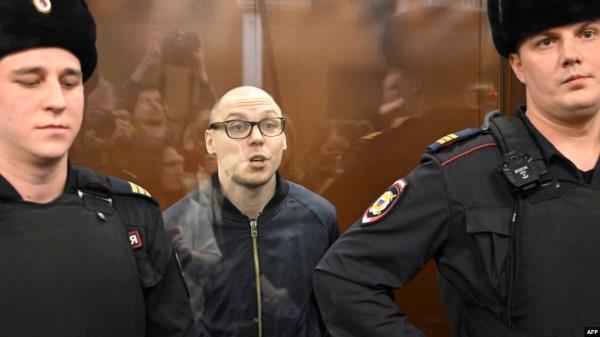 Russian poet Artyom Kamardin stands inside the defendants' glass cage during his verdict announcement at a court in Moscow on Dec. 28, 2023. He received a seven-year sentence for reciting versus against Russia's war in Ukraine. 