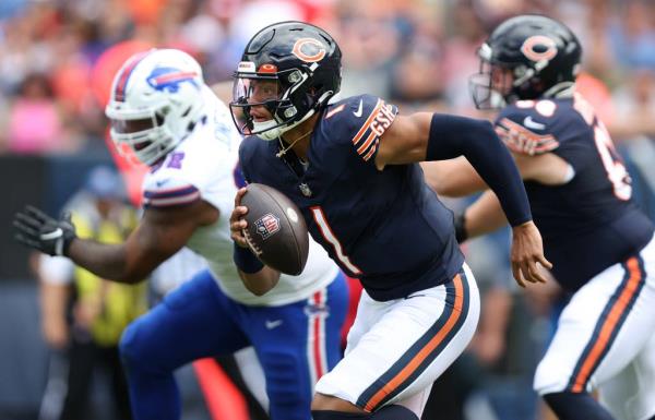 Bears quarterback Justin Fields scrambles out of the pocket in the first quarter of a preseason game against the Bills at Soldier Field on Aug. 26, 2023.