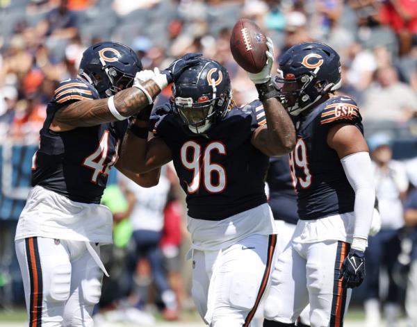 Bears defensive tackle Zacch Pickens celebrates after recovering a fumble against the Titans in the second quarter of a preseason game at Soldier Field on Aug. 12, 2023.