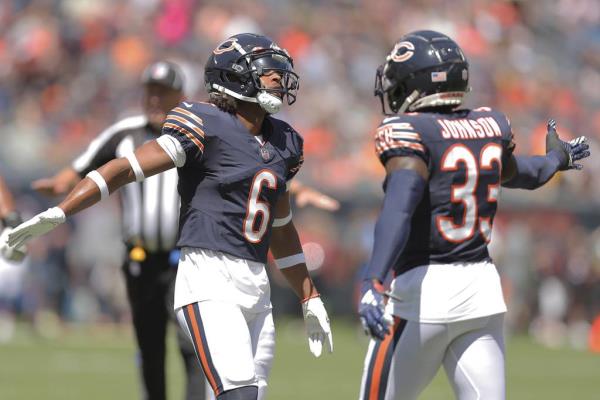 Bears cornerbacks Kyler Gordon and Jaylon Johnson celebrate after a stop on third down during the first half against the Titans on Aug. 12, 2023.