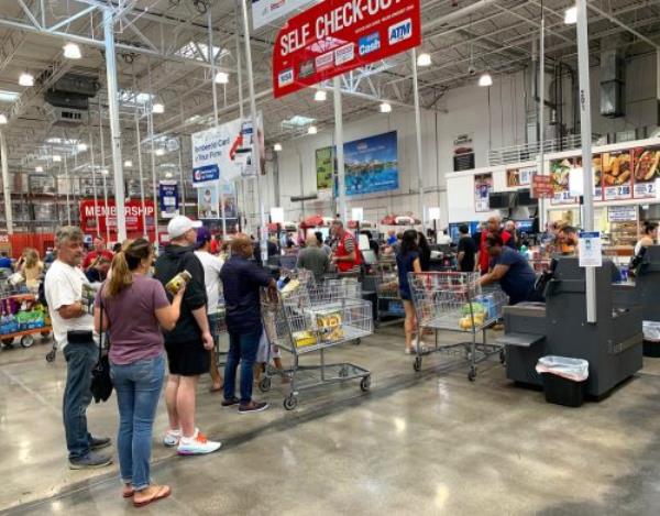 Customers standing on line to check out of Costco. Costco is an American corporation that operates a chain of members o<em></em>nly warehouse clubs as seen on October 26, 2019.