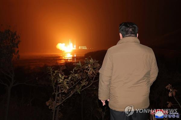 North Korean leader Kim Jong-un watches a new type of Chollima-1 rocket carrying a reco<em></em>nnaissance satellite called the Malligyong-1 being launched from the Sohae satellite launch site in Tongchang-ri in northwestern North Korea at 10:42 p.m. on Nov. 21, 2023, in this photo released the next day by the North's official Korean Central News Agency. (For Use o<em></em>nly in the Republic of Korea. No Redistribution) (Yonhap)