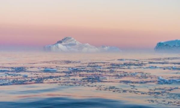 Huge stranded icebergs at the mouth of the Icejord near Ilulissat at midnight, Greenland.