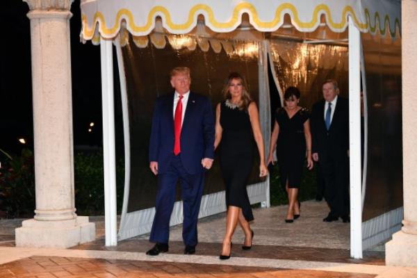 Former President Do<em></em>nald Trump (left) said his wife Melania Trump (second from right) has been ata hospital with her sick mother, Amialija Knav (second from left)