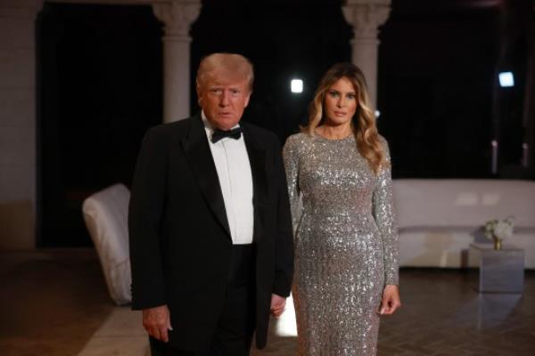 Former President Do<em></em>nald Trump (left) revealed his wife Melania Trump's (right) wher<em></em>ea<em></em>bouts during a New Year's Eve party at Mar-a-Lago 