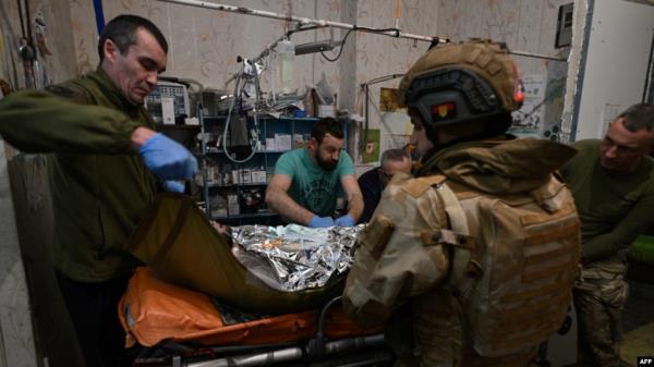 FILE - Ukrainian military medics treat a wounded Ukrainian serviceman at a stabilisation point near Bakhmut, Do<em></em>netsk region, on Feb. 9, 2024,