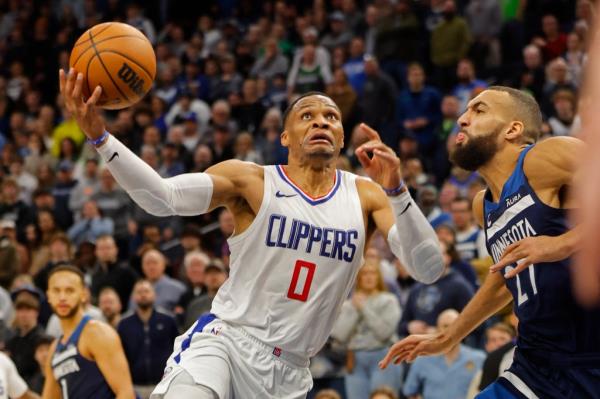 Los Angeles Clippers guard Russell Westbrook (0) shoots against Minnesota Timberwolves center Rudy Gobert (27) in the fourth quarter at Target Center. on January 14, 2024. 