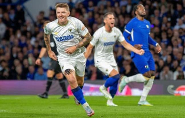 AFC Wimbledon’s James Tilley celebrates putting his side ahead from the penalty spot.