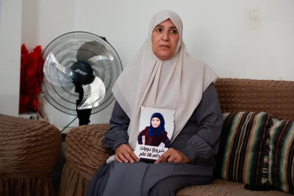 Sameera Dwayyat, the mother of Shorouq Dwayyat, 26, a female Palestinian priso<em></em>ner serving a 16-year sentence, holds a picture of her daughter.