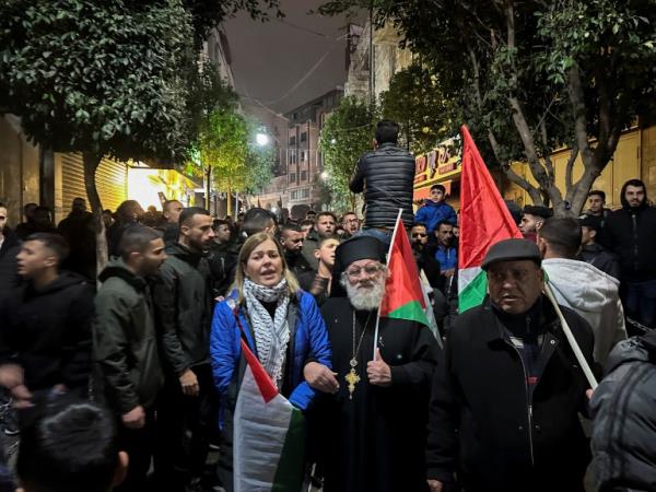 Palestinians take part in a protest against the killing of senior Hamas official