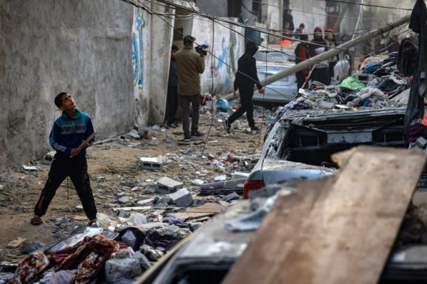 People assess the damage caused by Israeli bombardment in Rafah in the southern Gaza Strip on February 9