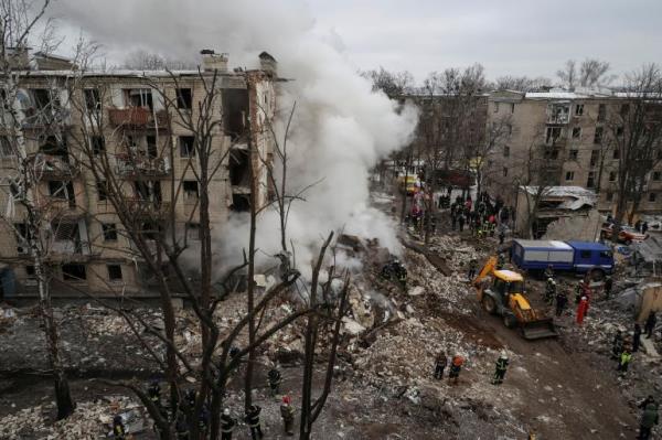 Rescuers work at a site of a residential building heavily damaged during a Russian missile attack, amid Russia's attack on Ukraine, in Kharkiv