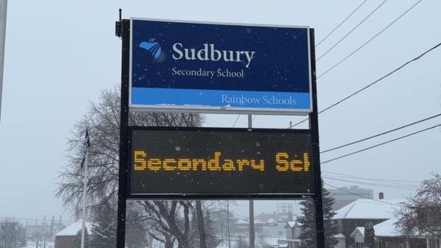 A blue sign that says Sudbury Seco<em></em>ndary School.