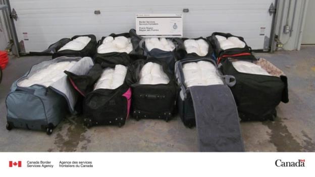 Bags of drugs sit inside suitcases.