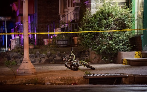 Bicycle belo<em></em>nging to a child victim who survived shots to the leg, lies at the scene of the mass shooting in Philadelphia