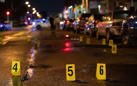 Police officials work at the scene of the mass shooting in South Philadelphia