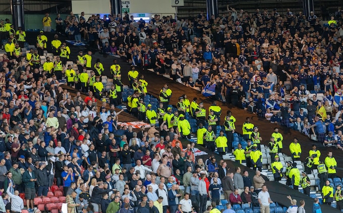 England and Scotland fans are separeted by police in stands