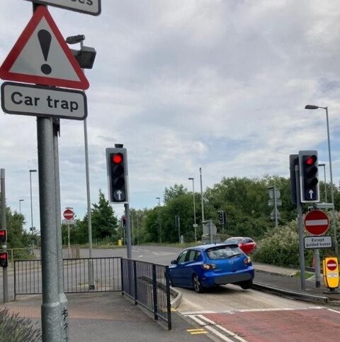 The pit in the road is wide enough that small vehicles fall into it