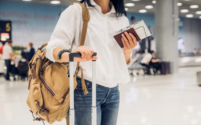 Woman backpacker holding passport