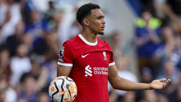 Trent Alexander-Arnold of Liverpool reacts to referee Anthony Taylor booking him for time-wasting at Stamford Bridge