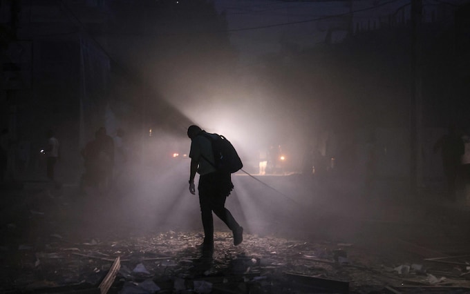 A man finds his way along a debris-strewn street in Gaza