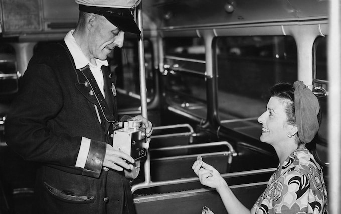 Lo<em></em>ndon bus co<em></em>nductor Albert West tests an automatic ticket machine on the Number 14 bus between Hornsey and Putney