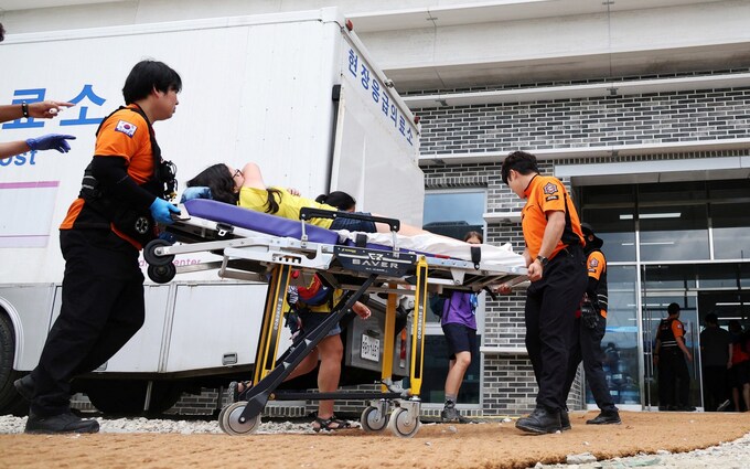 A young participant is carried on a stretcher to the site hospital during the 25th World Scout Jamboree in Buan, South Korea