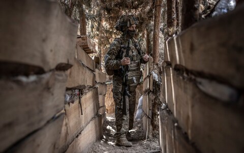 Ukrainian soldier taking cover at a front line position