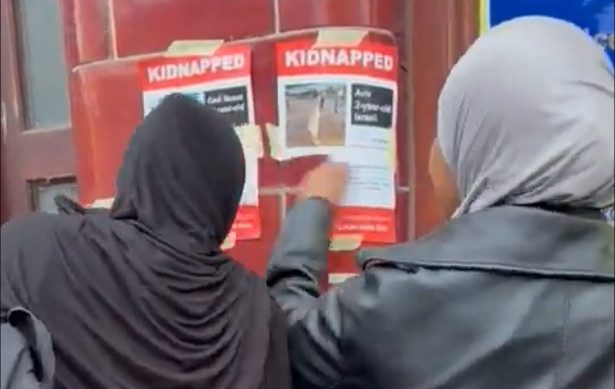 Footage shared on social media shows two women ripping the posters from walls in north London