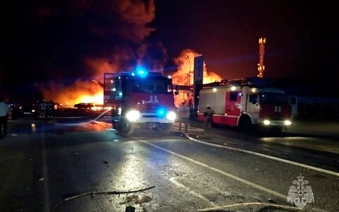 Rescuers work to put out a fire at the accident scene