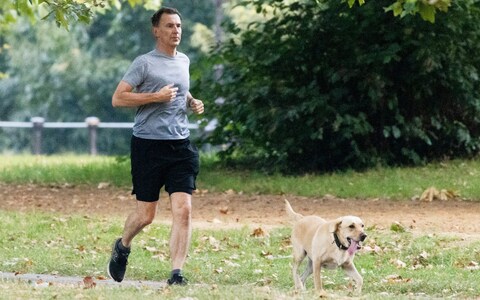 Jeremy Hunt, the Chancellor, is pictured running with his dog Poppy in central Lo<em></em>ndon this morning 