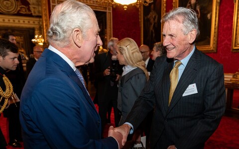 The King greets Sir Michael Palin at Buckingham Palace