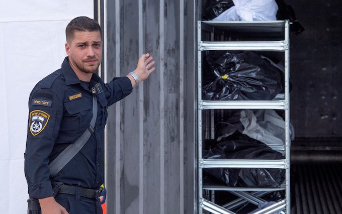 Body bags co<em></em>ntaining the remains of victims killed by Hamas are stacked at the Shura Army ba<em></em>se by Israeli police