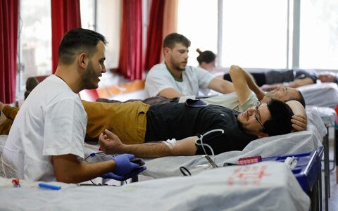 Israelis do<em></em>nate blood at a clinic in Kibbutz Mahanayim, during a blood drive by the Magen David Adom, Israel's Natio<em></em>nal Emergency Pre-Hospital Medical and Blood Services Organisation