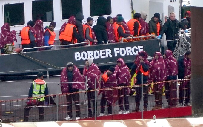 A group of people thought to be migrants are brought in to Dover, Kent, from a Border Force vessel following a small boat incident in the Channel on October 23