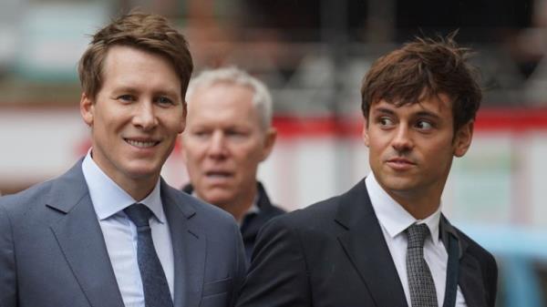 Dustin Lance Black (L) arrives at Westminster Magistrates' Court with his husband Tom Daley