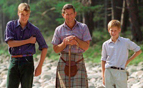 Prince Charles holding a walking stick styled as a shepherd's crook with Prince William and Prince Harry at Polvier, by the River Dee, Balmoral Castle estate