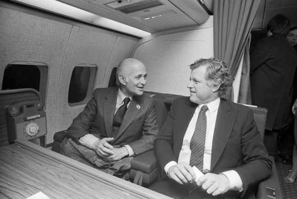 (Original Caption) 12/7/1979- Sioux City, IA- Television comedy producer Norman Lear (L) gets a laugh 12/7 from Senator Edward Kennedy, as the two talk aboard Kennedy's campaign plane flying over Iowa. Lear joined the Kennedy entourage during the Democratic presidential candidate's Iowa swing, traveling as what Lear termed "an observer".