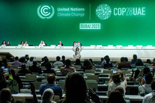 This image grab taken from AFPTV video footage shows an activist protesting on stage against fossil fuels during an event at the United Nations Climate Co<em></em>nference (COP28) in Dubai on December 11, 2023.