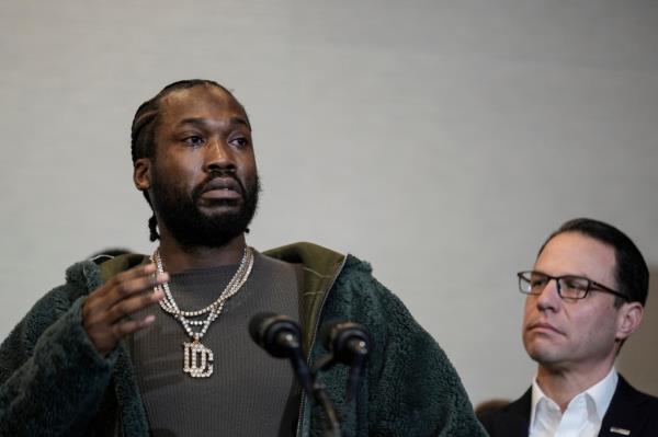 Rapper Meek Mill, left, accompanied by Pennsylvania Gov. Josh Shapiro, speaks during a ceremo<em></em>nial bill-signing in Philadelphia.