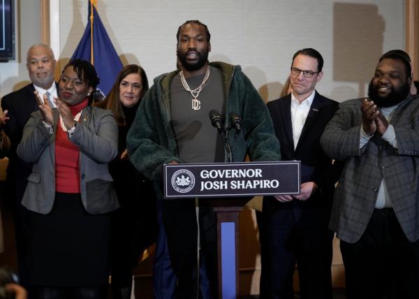 Rapper Meek Mill, center, speaks during a ceremo<em></em>nial bill-signing in Philadelphia, Friday, Dec. 15, 2023.