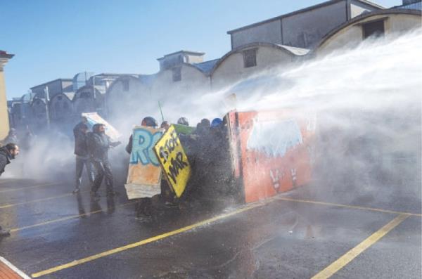 Police use a water cannon on Italians protesting against the presence of an Israeli pavilion at Vicenzaoro.—AFP