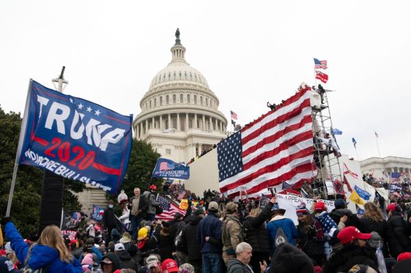 Violent insurrectio<em></em>nists loyal to President Do<em></em>nald Trump stand outside the U.S. Capitol in Washington on Jan. 6, 2021. 