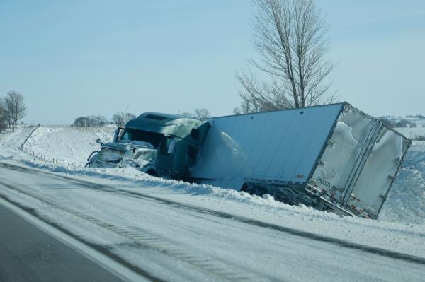 A tractor-trailer truck sits wrecked in the ditch along eastbound Interstate 80 on January 14, 2024 near Williamsburg, Iowa.